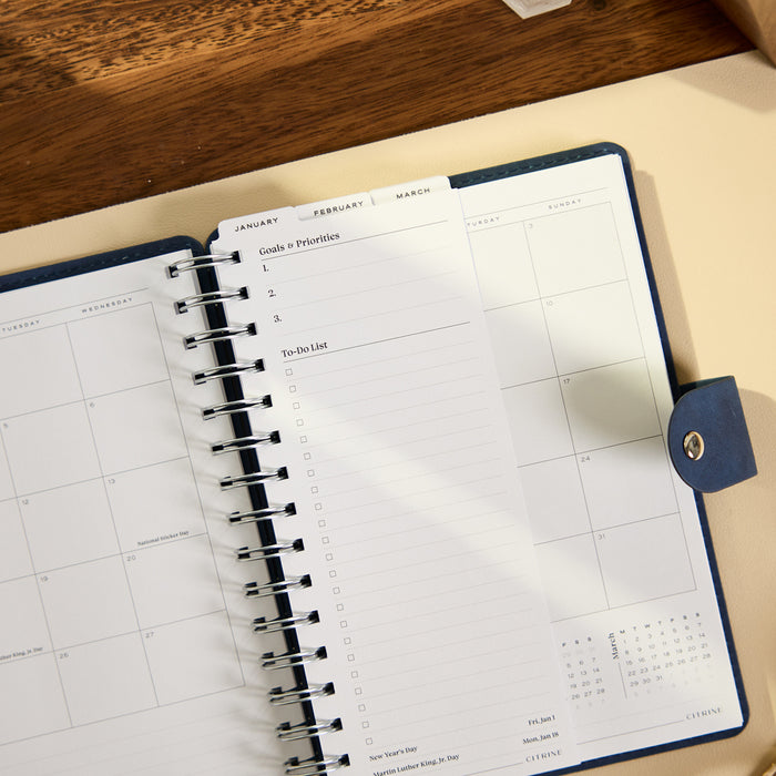 2027 Navy Customizable Spiral Citrine Planner - Small Professional Layout - 12 Months open to monthly calendar and priorities pages with spiral binding and navy cover