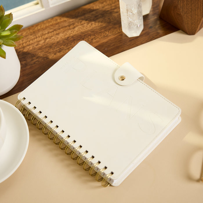 2027 Notes & Plans Customizable Spiral Citrine Planner - Small Professional Layout - 12 Months on a desk with blank pages, gold spiral binding, and snap closure