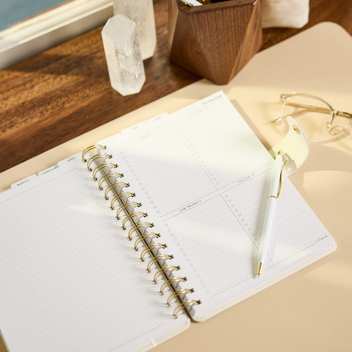 2027 Notes & Plans Customizable Spiral Citrine Planner - Small Professional Layout - 12 Months open with lined pages, weekly planning sections, gold spiral binding, and pen