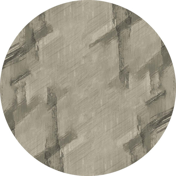 Circular rug in taupe and charcoal with an abstract, distressed brushstroke pattern.