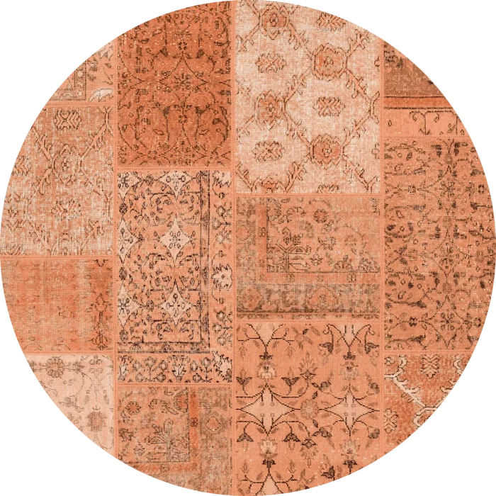 The Terracotta Patch - Washable Rug (JRN1037) is a round, flat weave rug in custom sizes, showcasing a patchwork design with orange and terracotta shades and detailed floral and geometric patterns in each section.