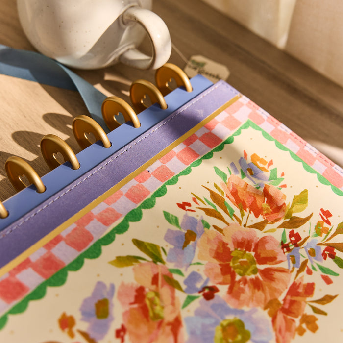 Close-up of a floral-patterned cover with gold discs and purple accents on the 2026–2027 SPECIALTY French Papers Customizable Planner - Classic Horizontal Layout - 12 Months.