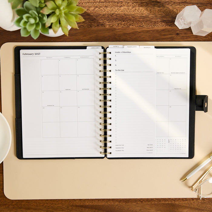2027 Midnight Customizable Spiral Citrine Planner - Classic Professional Layout - 12 Months open with monthly calendar and organized planning pages on a desk