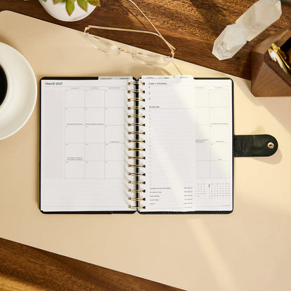 2027 Midnight Micro Dots Customizable Spiral Citrine Planner - Small Professional Layout - 12 Months open on a desk showing monthly and weekly pages