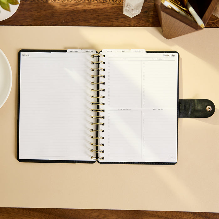 2027 Midnight Micro Dots Customizable Spiral Citrine Planner - Small Professional Layout - 12 Months open with lined notes and daily planning pages on a desk