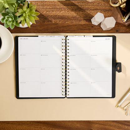 2027 Midnight Plaid Customizable Spiral Citrine Planner - Classic Professional Layout - 12 Months open to a clean weekly planning spread on a desk