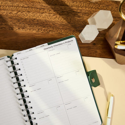 2027 Sage & Scallop Customizable Spiral Citrine Planner - Small Professional Layout - 12 Months open to a quarterly priorities and projects planning page beside a pen