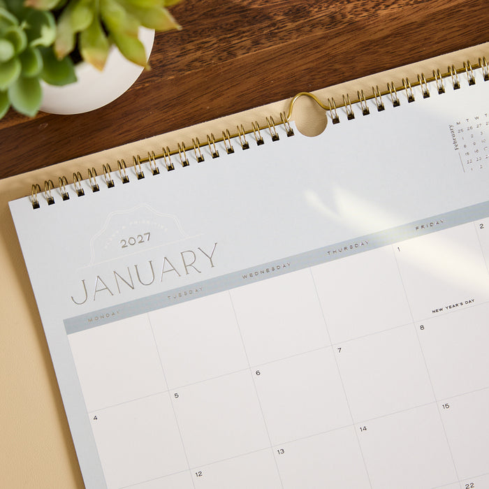 2027 Soft Frame Citrine Wall Calendar - Small - 12 Months open to January 2027 with a soft neutral frame and spacious monthly grid on a wooden desk