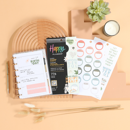 Apricot & Sage Mom - Value Pack Stickers displayed with a planner open to a birthday page, surrounded by a wooden tray, succulent plant, candle, gold pen, and dried grasses.