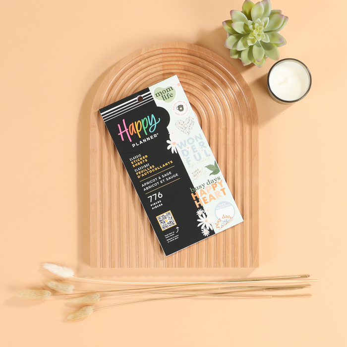 Apricot & Sage Mom - Value Pack Stickers for Happy Planner featuring various motivational and decorative designs, displayed on a wooden tray with a succulent plant and candle nearby.