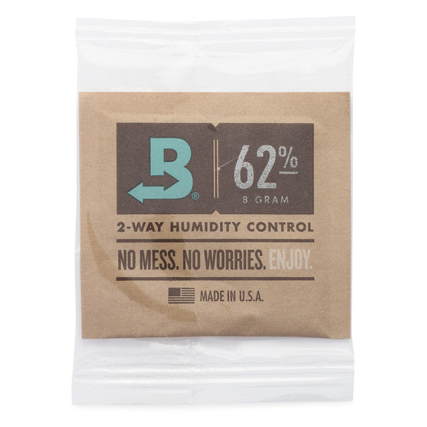 Boveda 62% humidity control packet in a small brown paper pouch for moisture regulation, shown inside clear packaging.