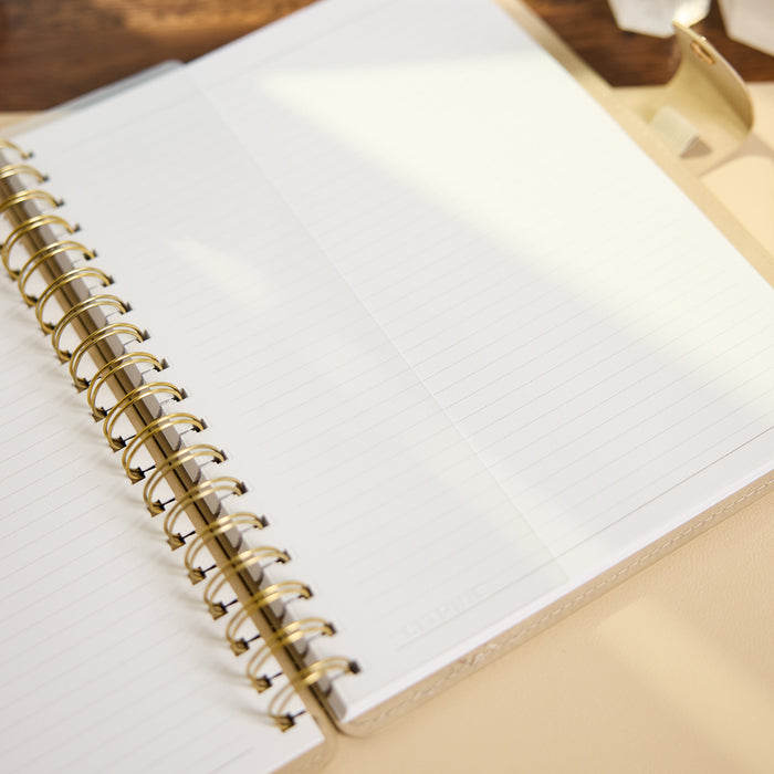 Citrine - Mocha - Classic Customizable Spiral Notebook with open lined pages and gold spiral binding on a warm neutral surface