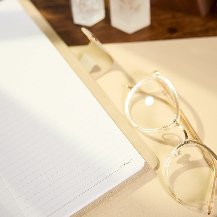 Citrine - Mocha - Classic Customizable Spiral Notebook with lined pages styled with eyeglasses and a pen on a warm neutral desk