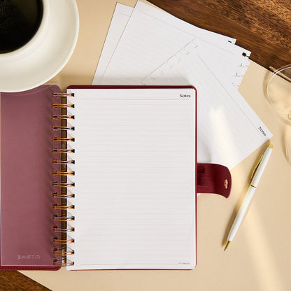 Citrine - Small Customizable Spiral Filler Paper open notebook with lined notes pages and gold spiral binding beside a pen and papers on a desk
