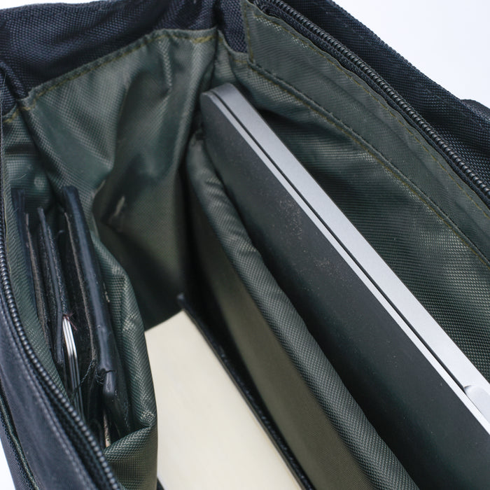 Open bag interior with laptop, book, organized compartments for daily essentials