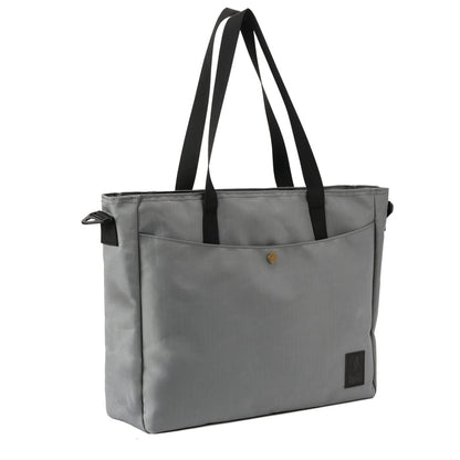 Gray tote bag with black straps and front pocket, minimalist travel accessory