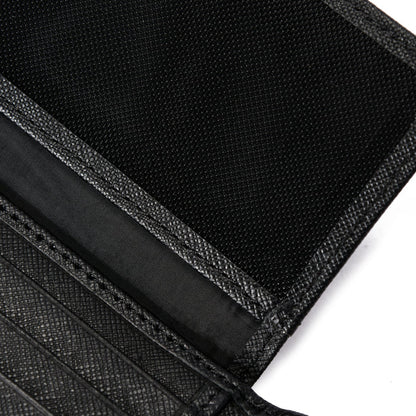 Close-up of black textured wallet interior with card slots and fabric lining