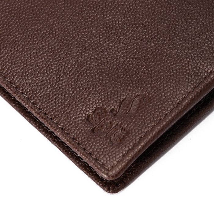 Close-up of brown textured leather wallet with embossed logo on white background