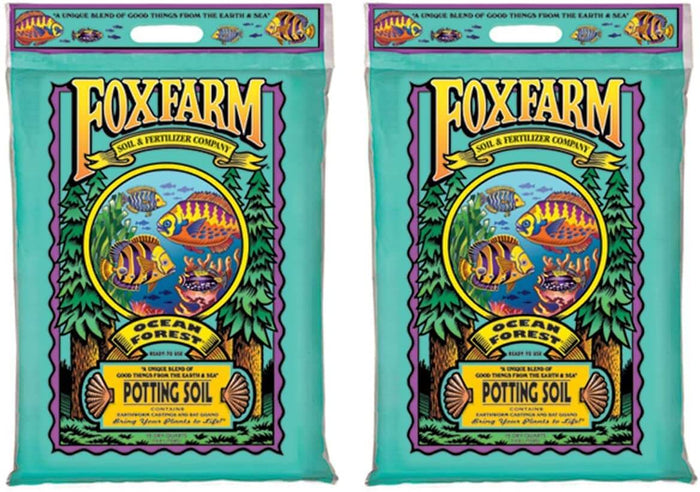 Two identical bags of FoxFarm Ocean Forest potting soil with a teal background and colorful fish illustration.