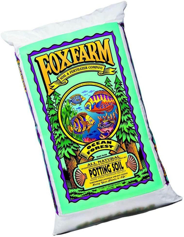 A bag of FoxFarm Ocean Forest potting soil with vibrant fish illustrations, green pine trees, and purple borders.
