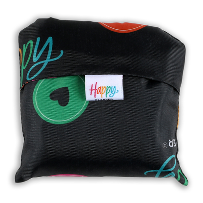 Compact black fabric pouch with colorful Happy Planner logo tag, containing the Happy Plans - Reusable Shopping Tote featuring a cheerful multicolor design.