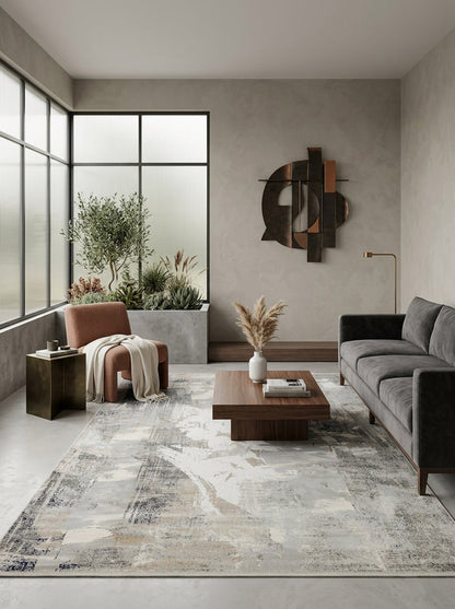 Grey and beige abstract distressed rug in a modern living room with a grey sofa and terracotta armchair.