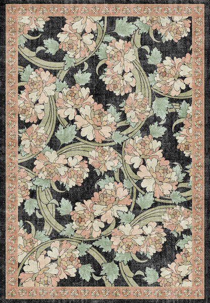 Black rug with a pink and sage green floral pattern and a decorative border.