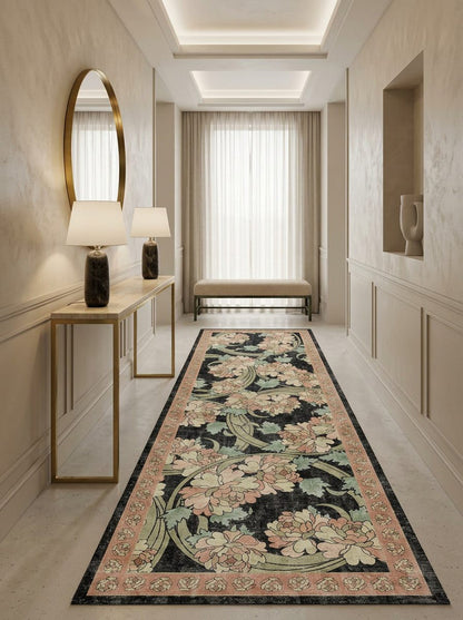 Black runner rug with a floral pattern in pink and sage green, styled in a neutral-toned hallway.