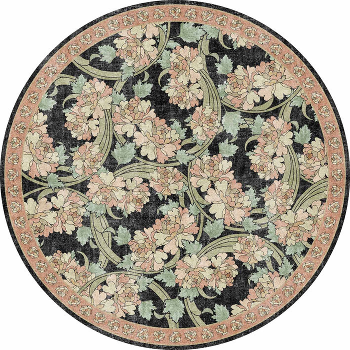 Round rug with a black background, featuring a floral pattern of pink peonies and sage green leaves with a floral border.