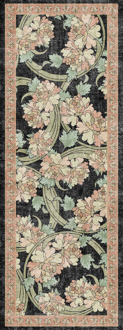 Black runner rug with a pink and sage green floral pattern and a repeating geometric border.
