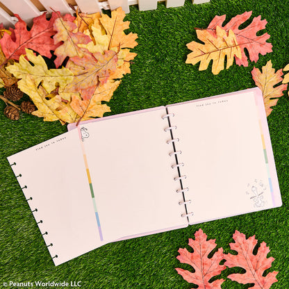 PEANUTS™ - Dotted Lined Classic Filler Paper - 40 Sheets open in a disc bound planner with pastel pages and autumn leaves on green grass