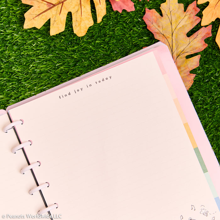 PEANUTS™ - Dotted Lined Classic Filler Paper - 40 Sheets open in a disc bound planner with pastel dividers and a cheerful decorative message