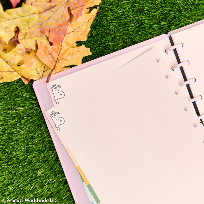 PEANUTS™ - Dotted Lined Classic Filler Paper - 40 Sheets shown in a pink disc bound planner with Snoopy illustrations and punched holes.