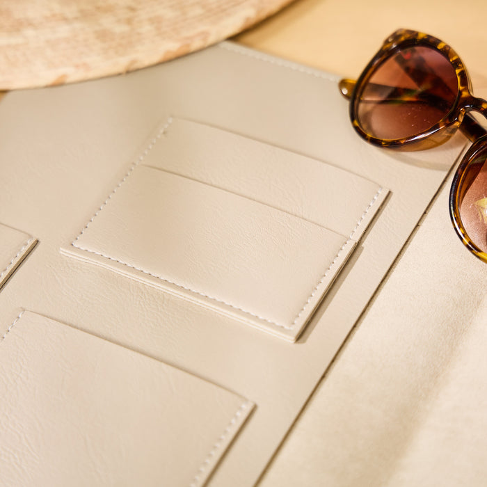 Taupe Vegan Leather - Deluxe Classic Planner Folio open to show interior card and accessory pockets next to tortoiseshell sunglasses on a neutral surface.