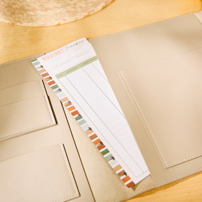 Taupe Vegan Leather - Deluxe Classic Planner Folio opened to show multiple pockets and a budget tracker insert with a colorful striped border inside the folio.