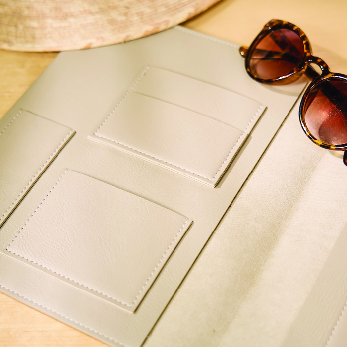 Open Taupe Vegan Leather - Deluxe Classic Planner Folio showing multiple interior pockets for cards and accessories next to tortoiseshell sunglasses on a wooden surface.