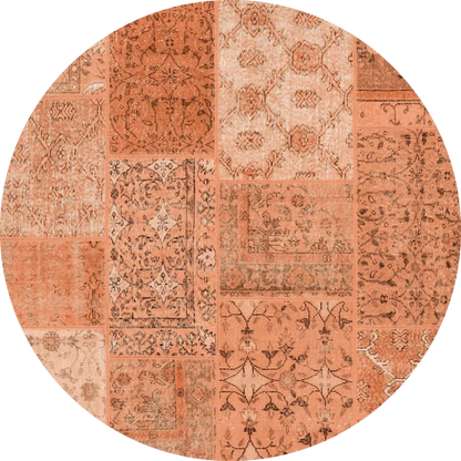 The Terracotta Patch - Washable Rug (JRN1037) is a round, flat weave rug in custom sizes, showcasing a patchwork design with orange and terracotta shades and detailed floral and geometric patterns in each section.