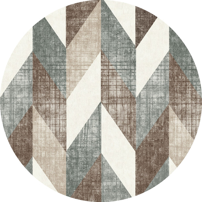 Round rug with a geometric chevron pattern in shades of brown, grey, and cream with a textured, distressed finish.