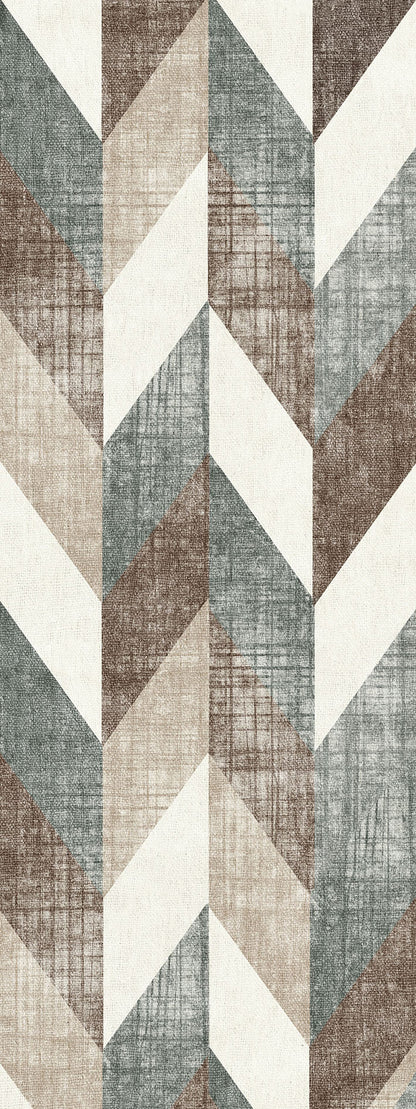 Geometric chevron rug with a distressed texture in shades of slate blue, brown, beige, and cream.