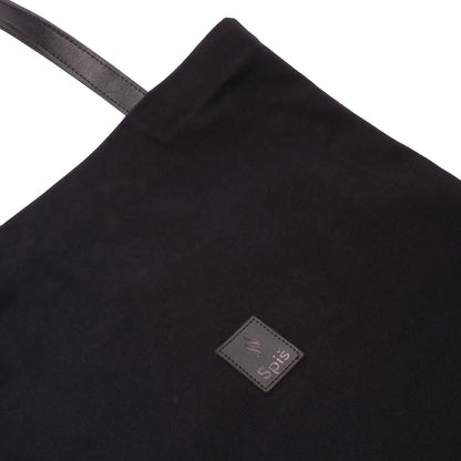 Black canvas tote bag with leather handle and stitched logo patch