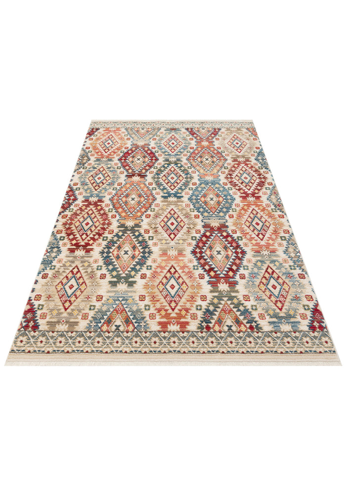 Cream rug with a multi-colored geometric diamond pattern in red, blue, and tan, featuring a fringed border.