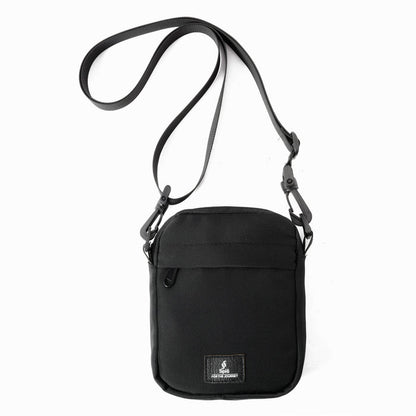 Black cross bag shoulder bag with adjustable strap and front pocket against a white background