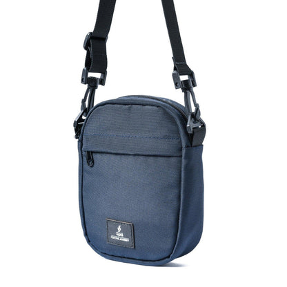 Small blue cross bag with black adjustable strap and front pocket