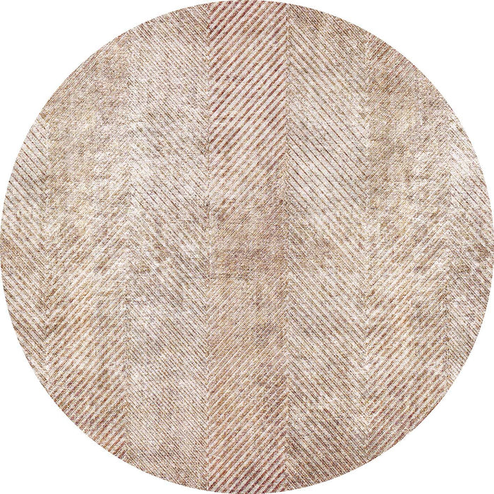 Round beige and tan rug with a distressed herringbone pattern.