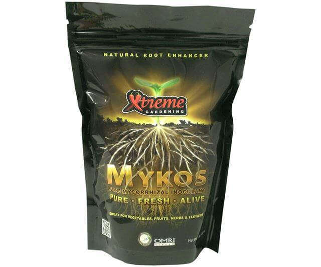 Black stand-up pouch of Xtreme Gardening Mykos mycorrhizal inoculant with a root and seedling graphic.